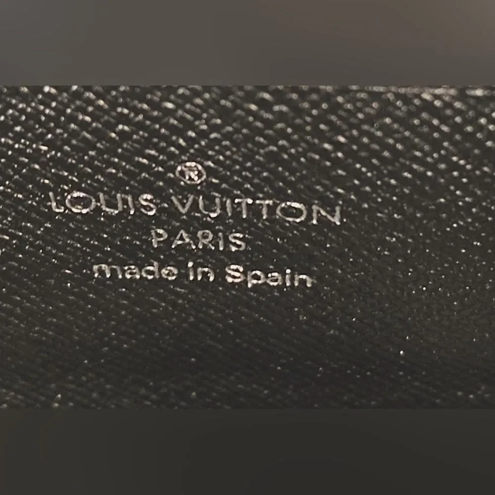 Auth Louis Vuitton black epi‎ wallet silver hardware.